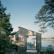 The Kråkmora Holmar House functions as a guest house for a home 25 feet uphill.