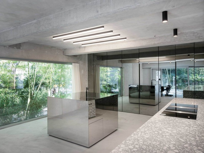 "Mirrored walls reflect the exposed concrete."