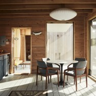 The kitchen includes a 1970s burke tulip table, vintage chairs by Kai Kristiansen and a George Nelson saucer bubble pendant from Herman Miller