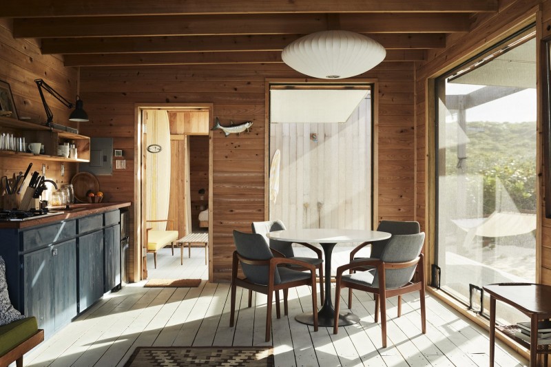 The kitchen includes a 1970s burke tulip table, vintage chairs by Kai Kristiansen and a George Nelson saucer bubble pendant from Herman Miller