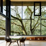 American studio Faulkner Architects has created a family residence clad in Corten steel panels and shaded by large oak trees.